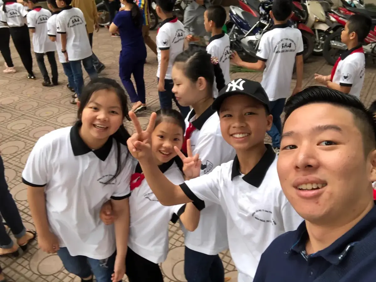 Sam with students at a school visit