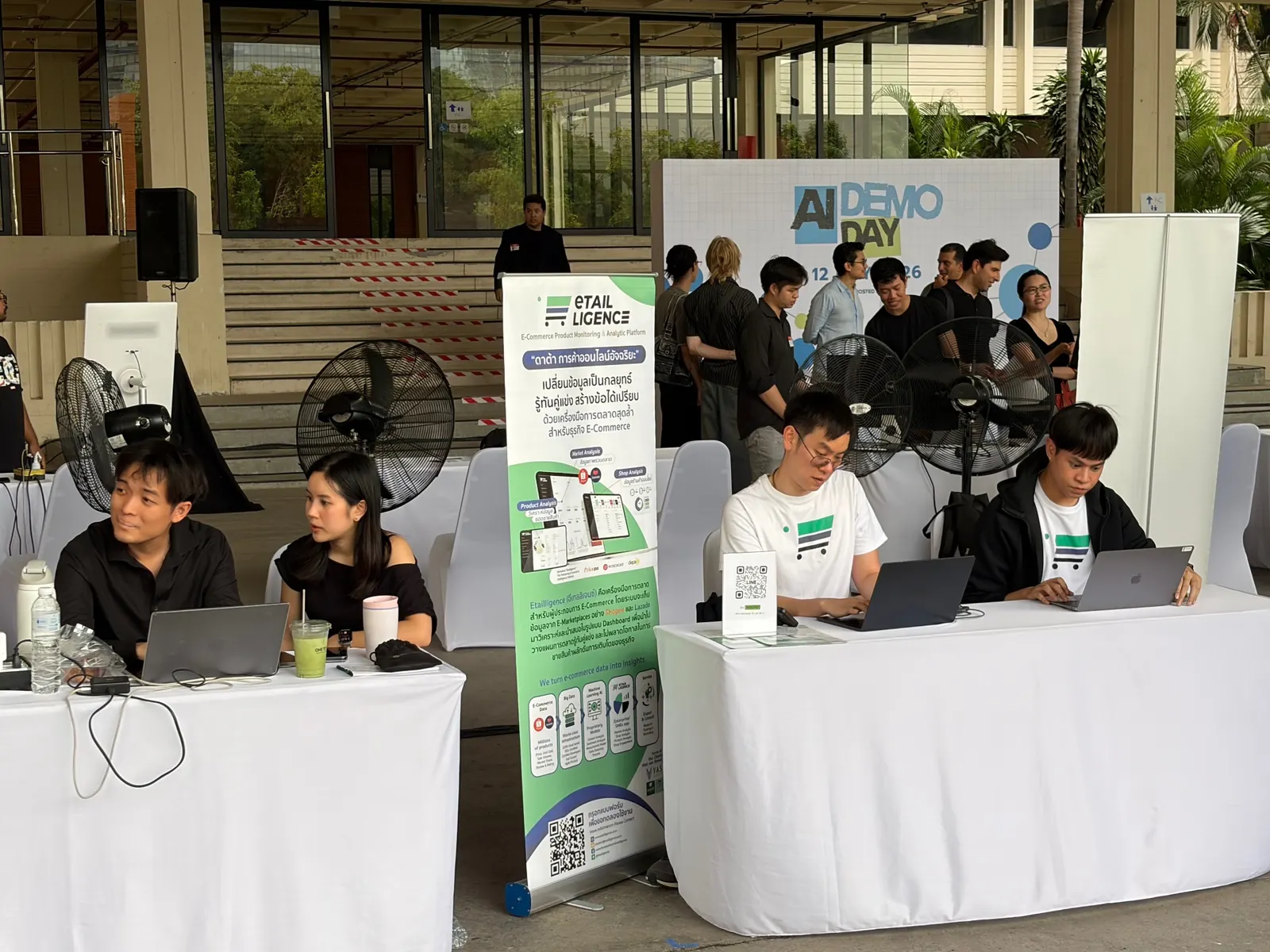 Exhibitor booths and teams at the AI Demo Day event