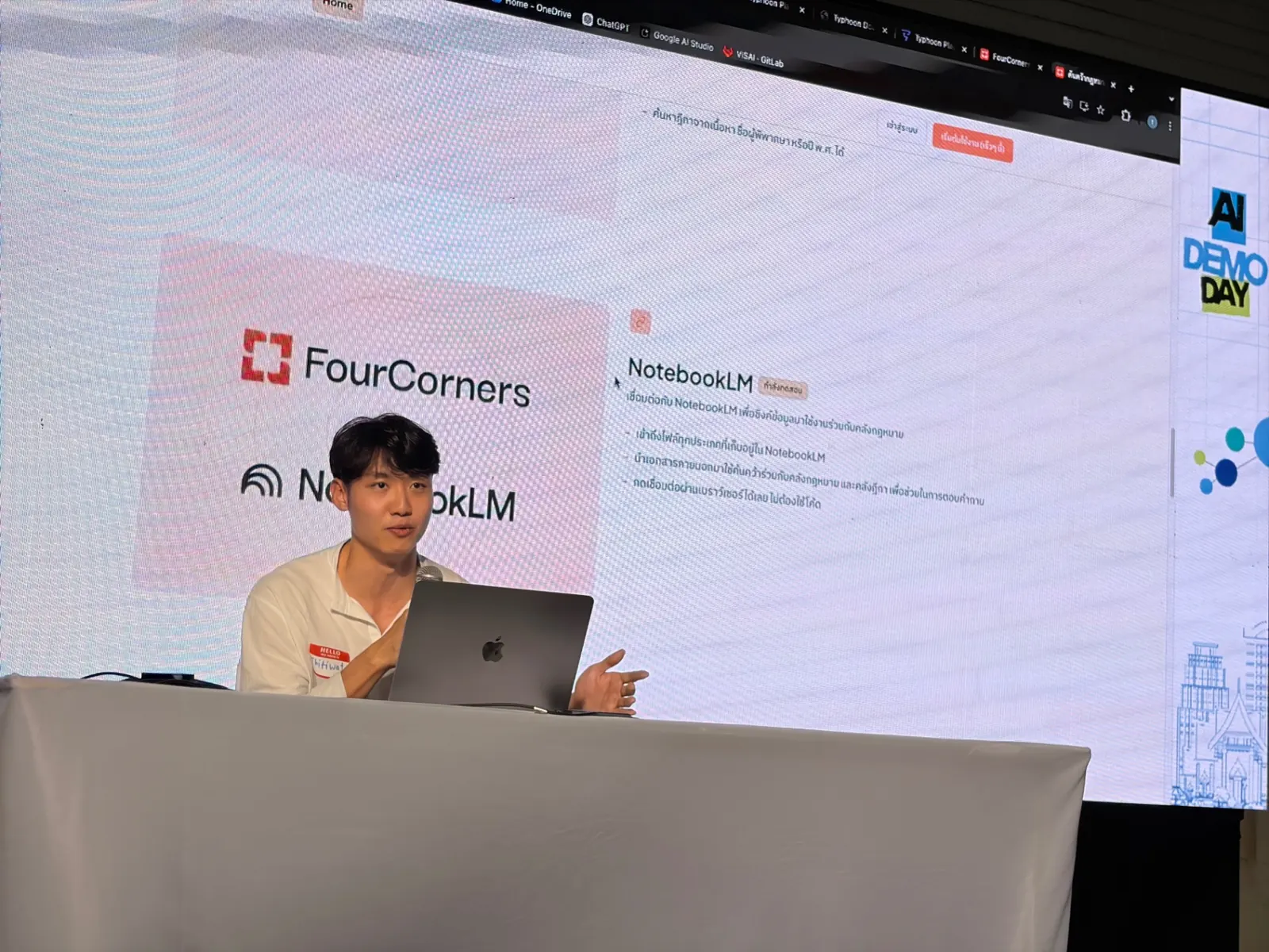 A student presenting an AI product build on stage at a demo day