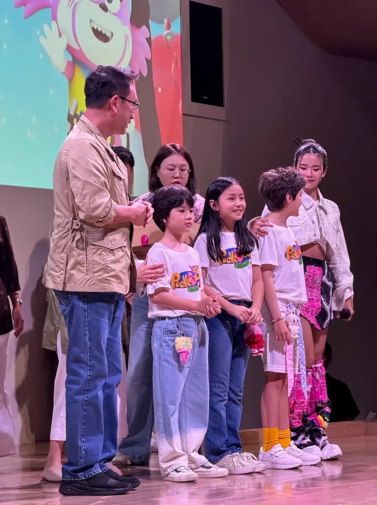 AIKS students presenting on stage