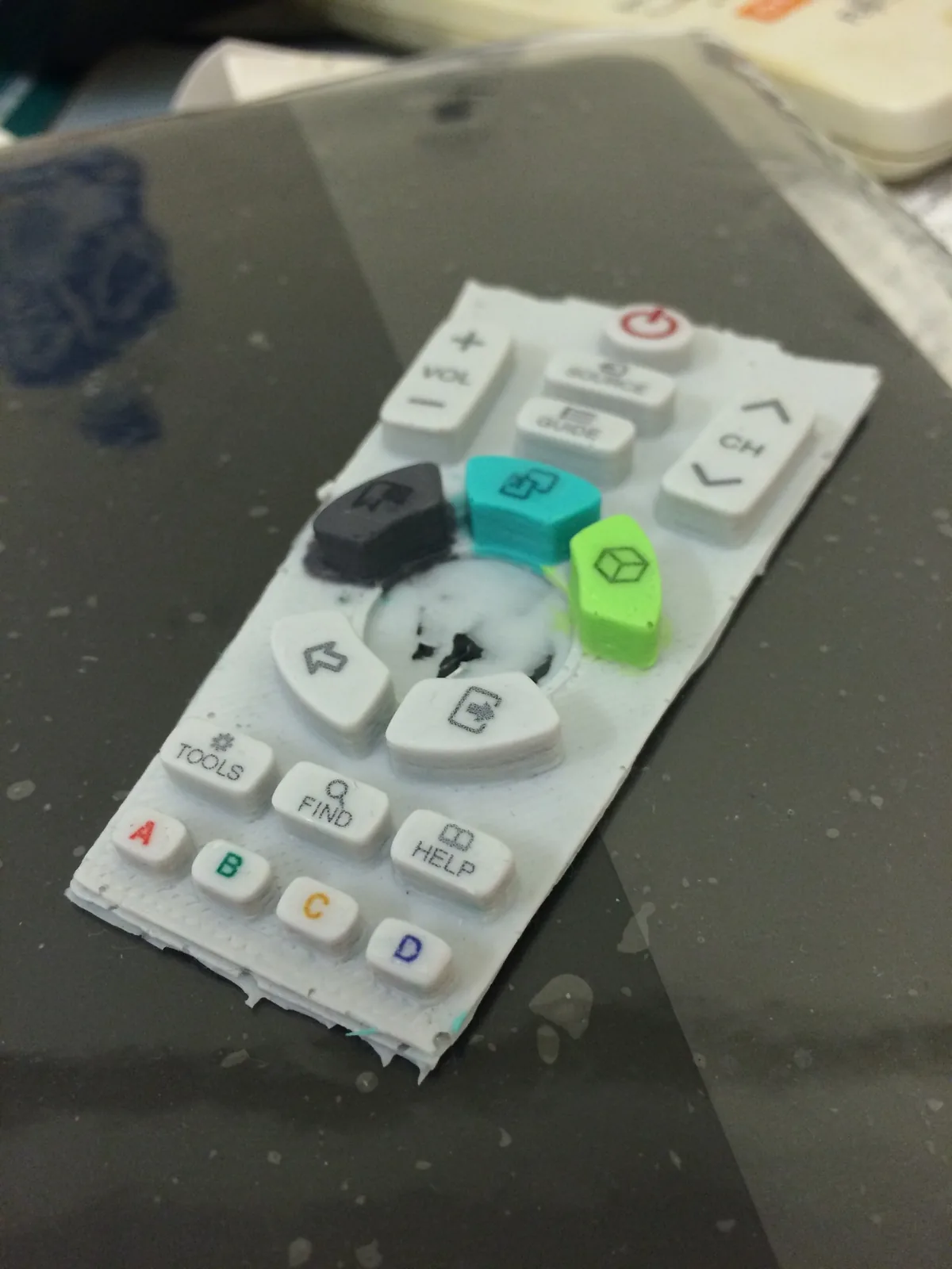 Remote button plate with applied labels for VOL, CH, TOOLS, FIND and HELP